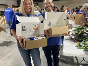 Grand Bank employees pack food at Extra Table event